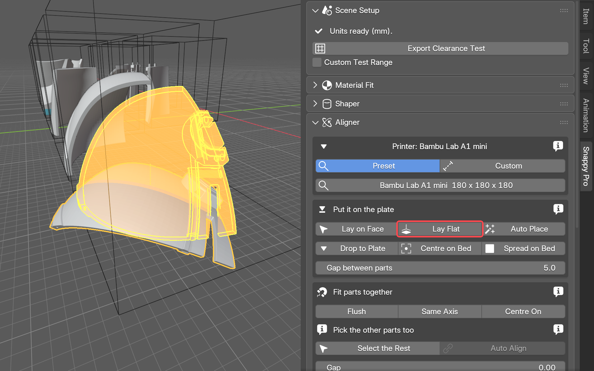 One helmet part laid flat on its biggest face, standing among the printer-bed outlines